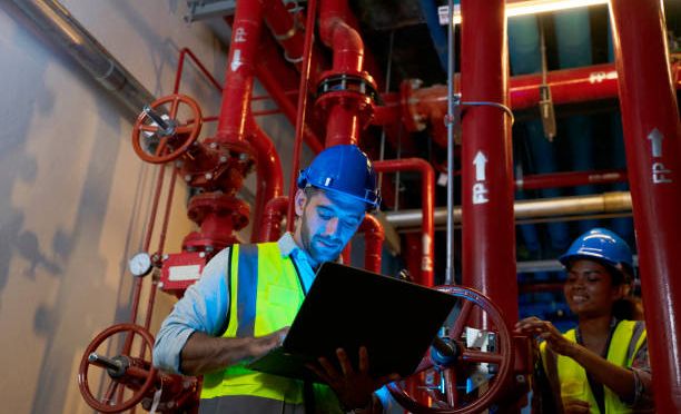 Engineer is working in the control room. At night time. Engineering concept.